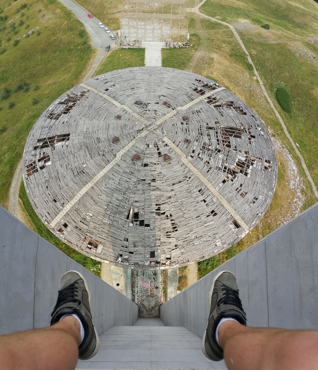 Buzludzha Monument: a saucer-like concrete mass embedded on a mountain summit.