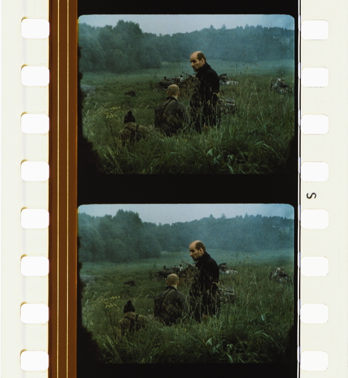 Stalker film frame: figures and ruin inside a damp, suspended space.