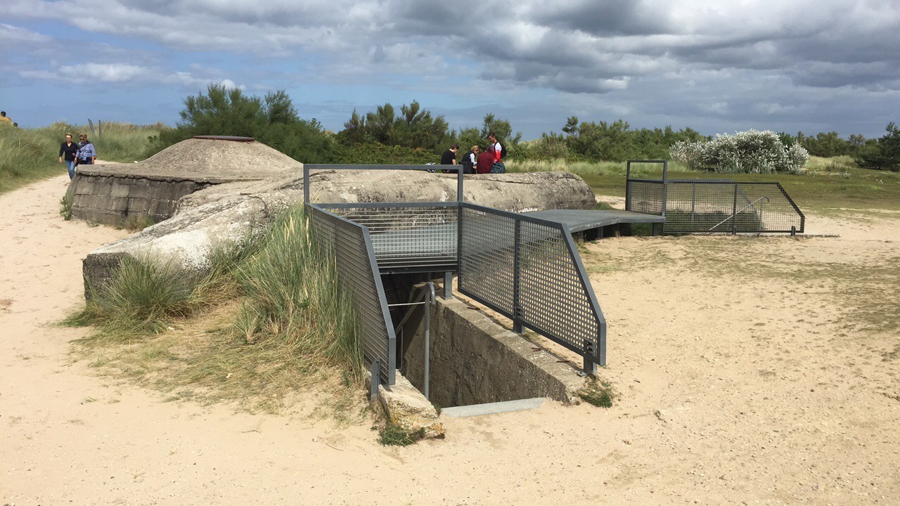 World War II concrete bunker: a low, heavy wall pressing against the horizon.